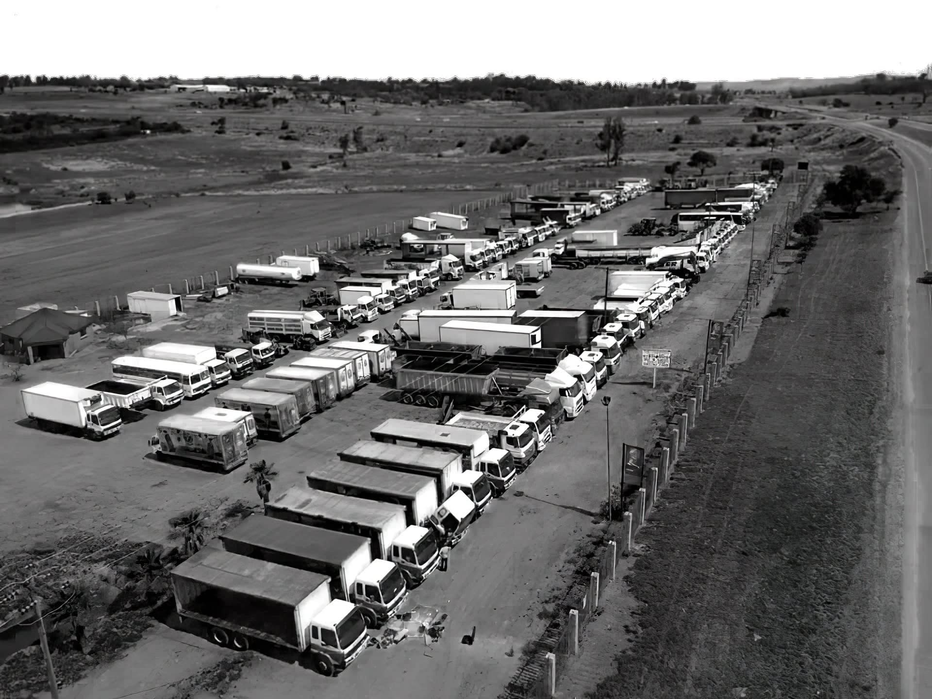 Aerial view of the SMT yard — trucks and commercial vehicles lined up for auction